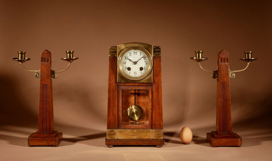 art nouveau/deco gustav serrurier-bovy (1858-1910) a rare oak and brass clock garniture, circa 1900-10